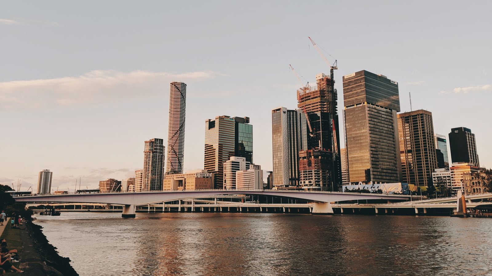 Panoramic view of the Brisbane city skyline and river during a clear afternoon