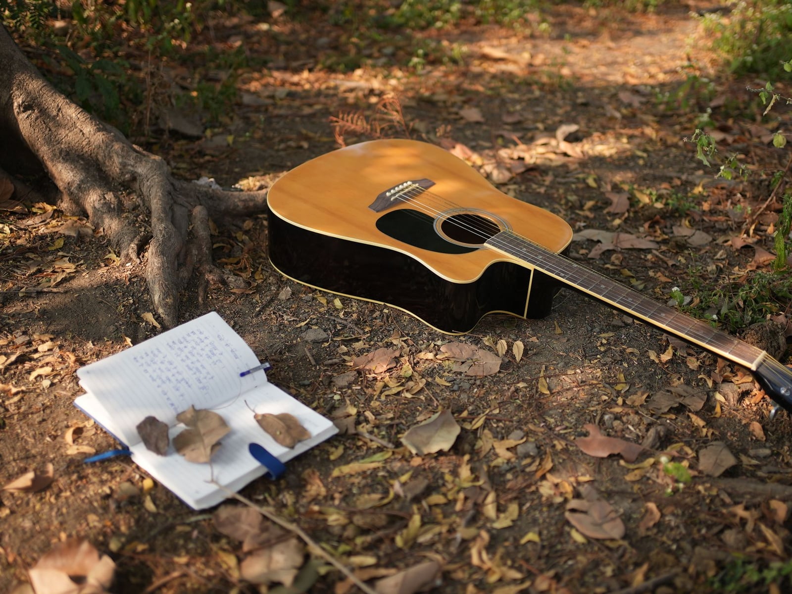 A notebook with song lyrics and a glass of water prepared for a recording session